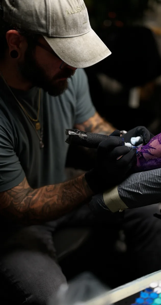 Bobby Cupparo's tattoo machine in hand — detail shot