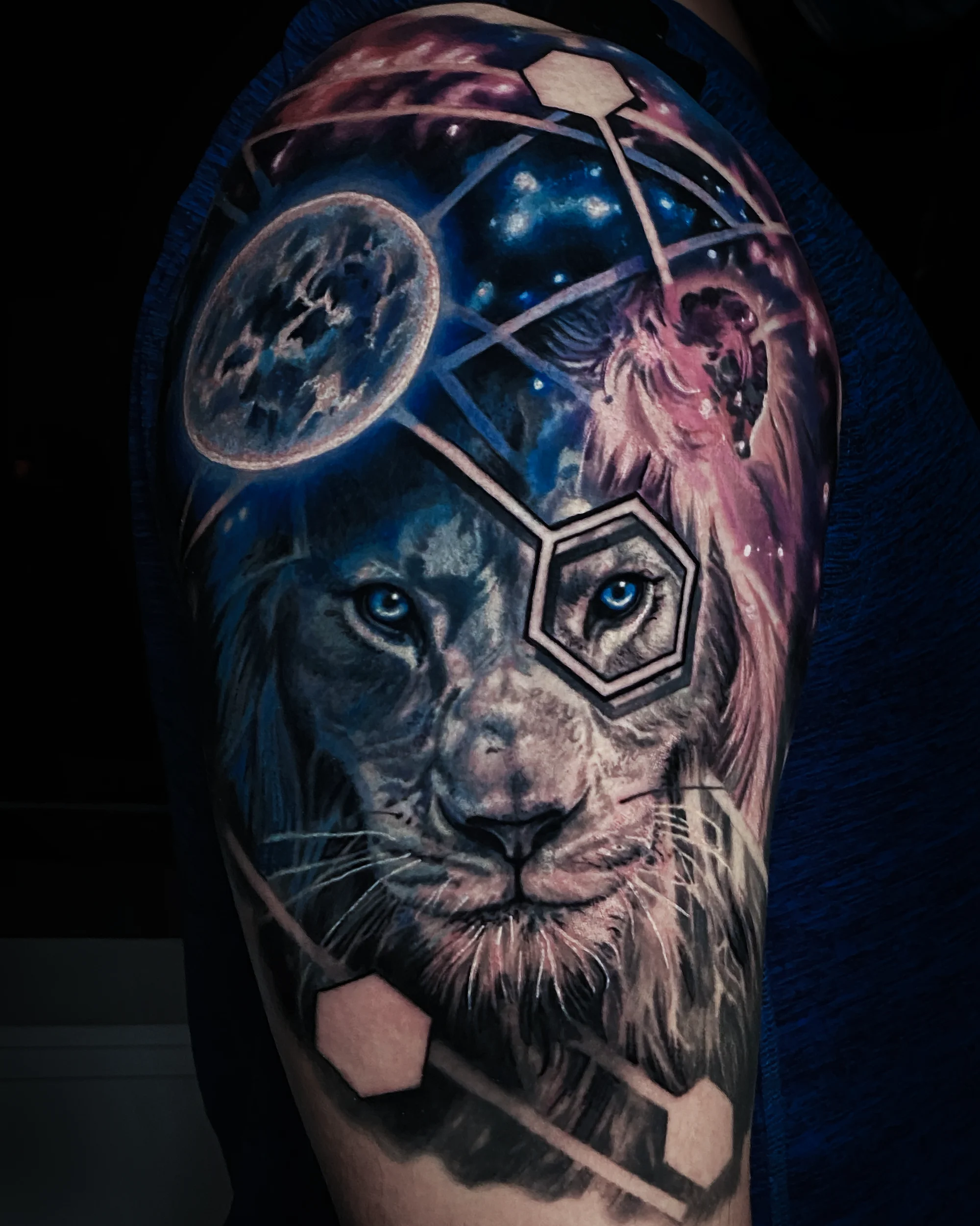 Cosmic lion geometric upper arm tattoo