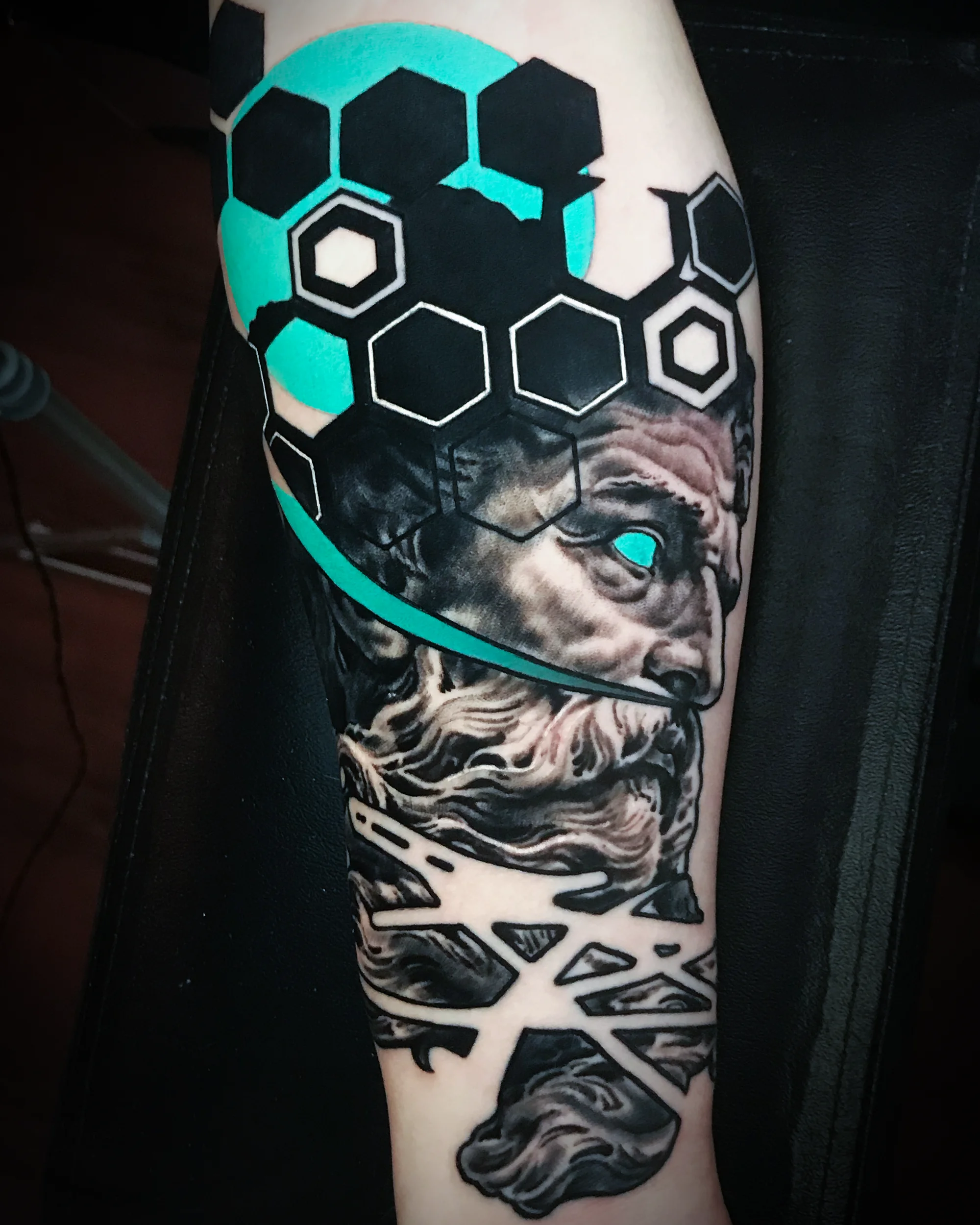Black and grey Zeus Greek god geometric honeycomb forearm tattoo by Austin tattoo artist Bobby Cupparo