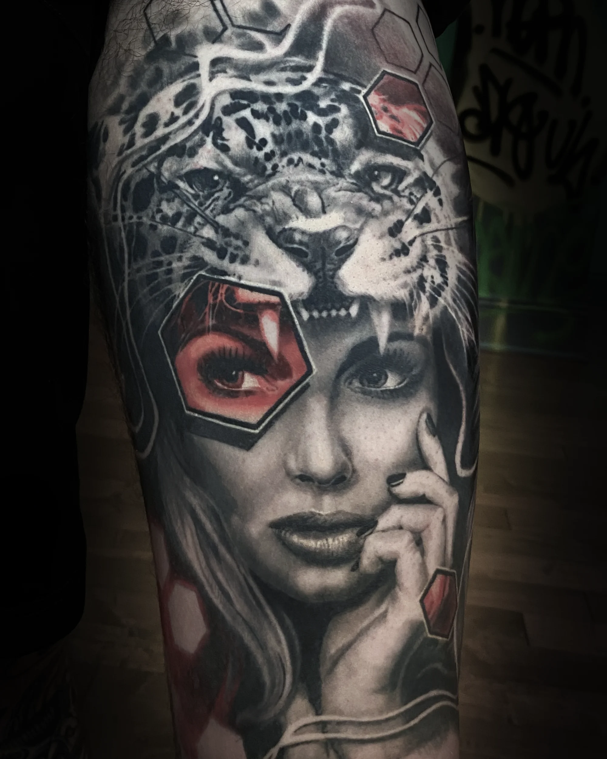 Surreal black and grey leopard headdress female portrait thigh tattoo by Austin tattoo artist Bobby Cupparo