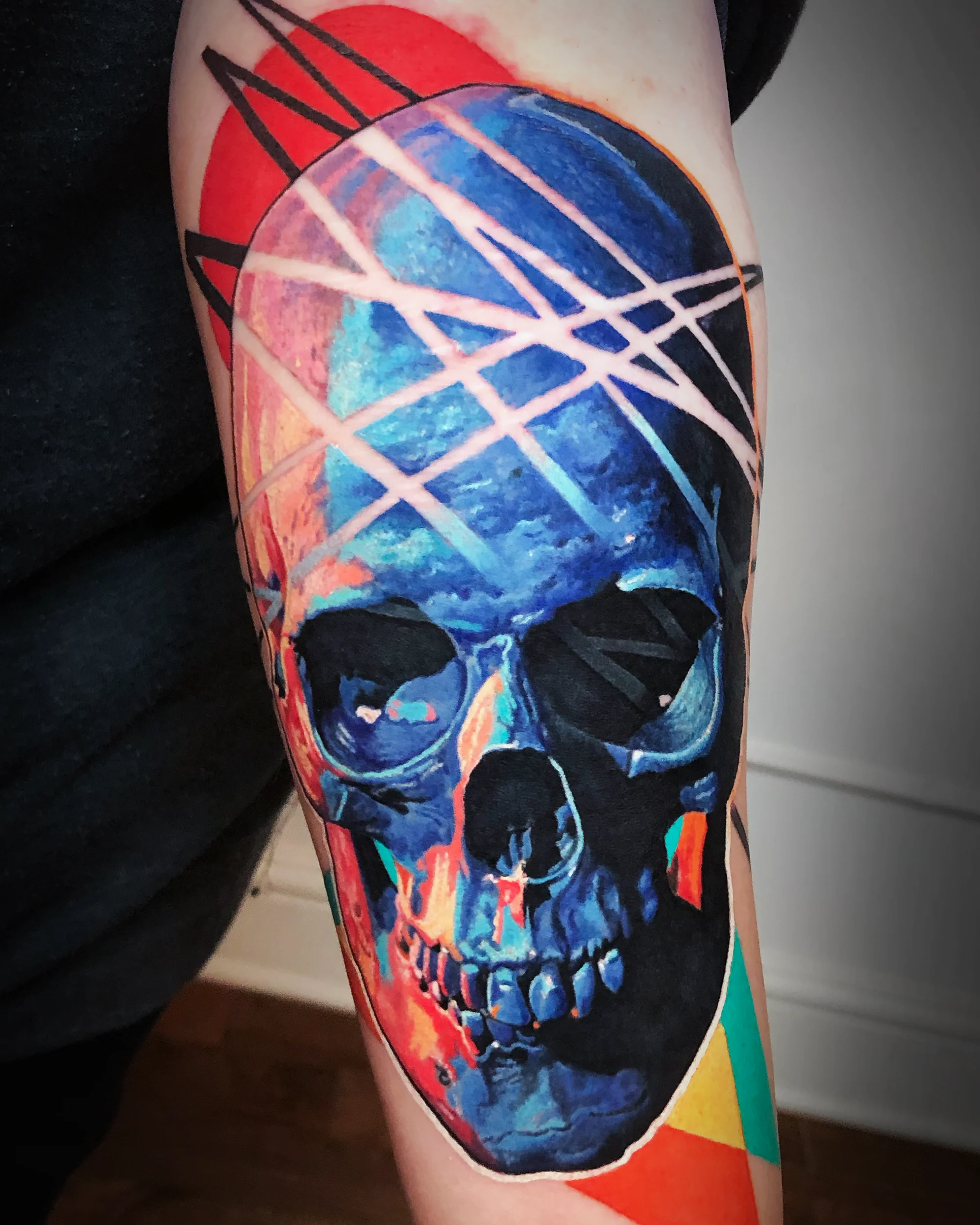 Abstract color realism neon skull forearm tattoo by Austin tattoo artist Bobby Cupparo