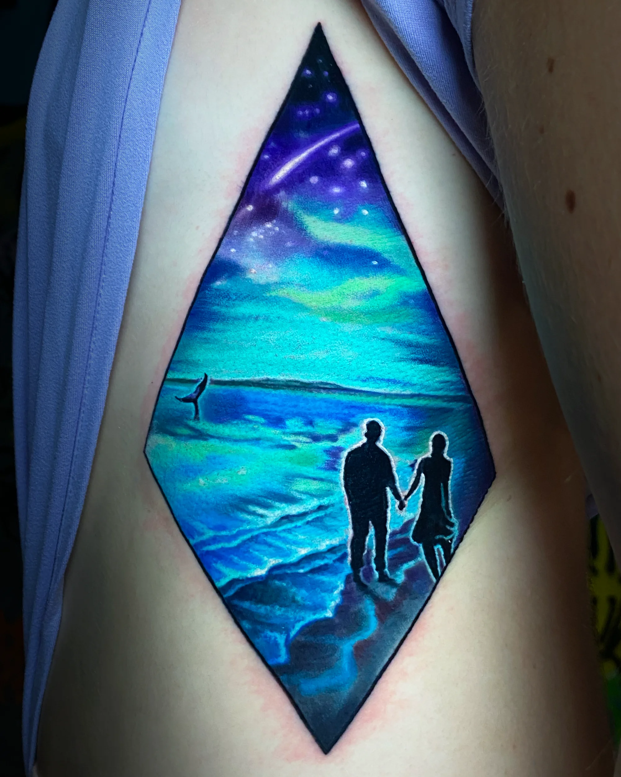 Color realism beach couple silhouette galaxy diamond thigh tattoo by Austin tattoo artist Bobby Cupparo