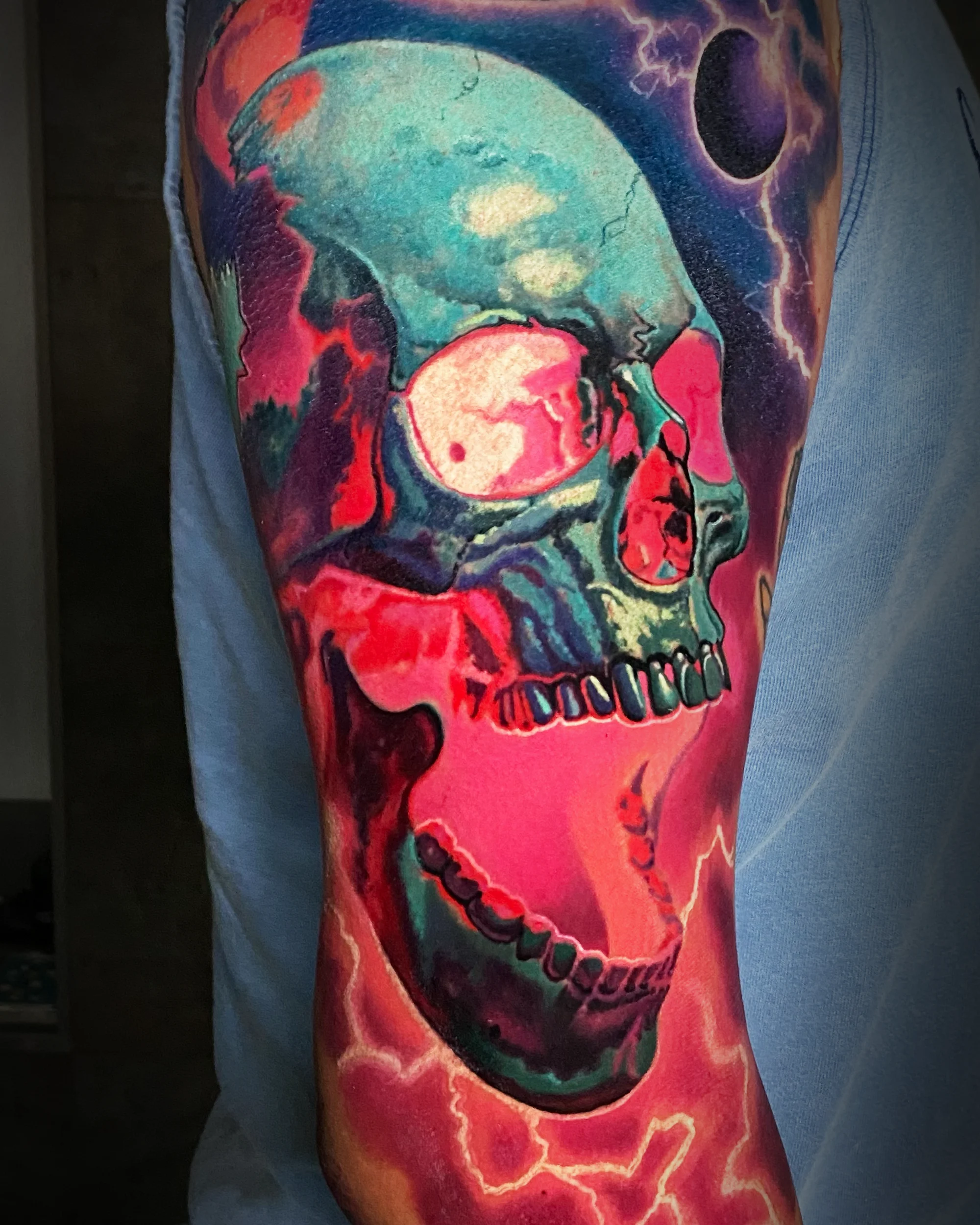 Color realism cosmic galaxy skull arm tattoo by Austin tattoo artist Bobby Cupparo