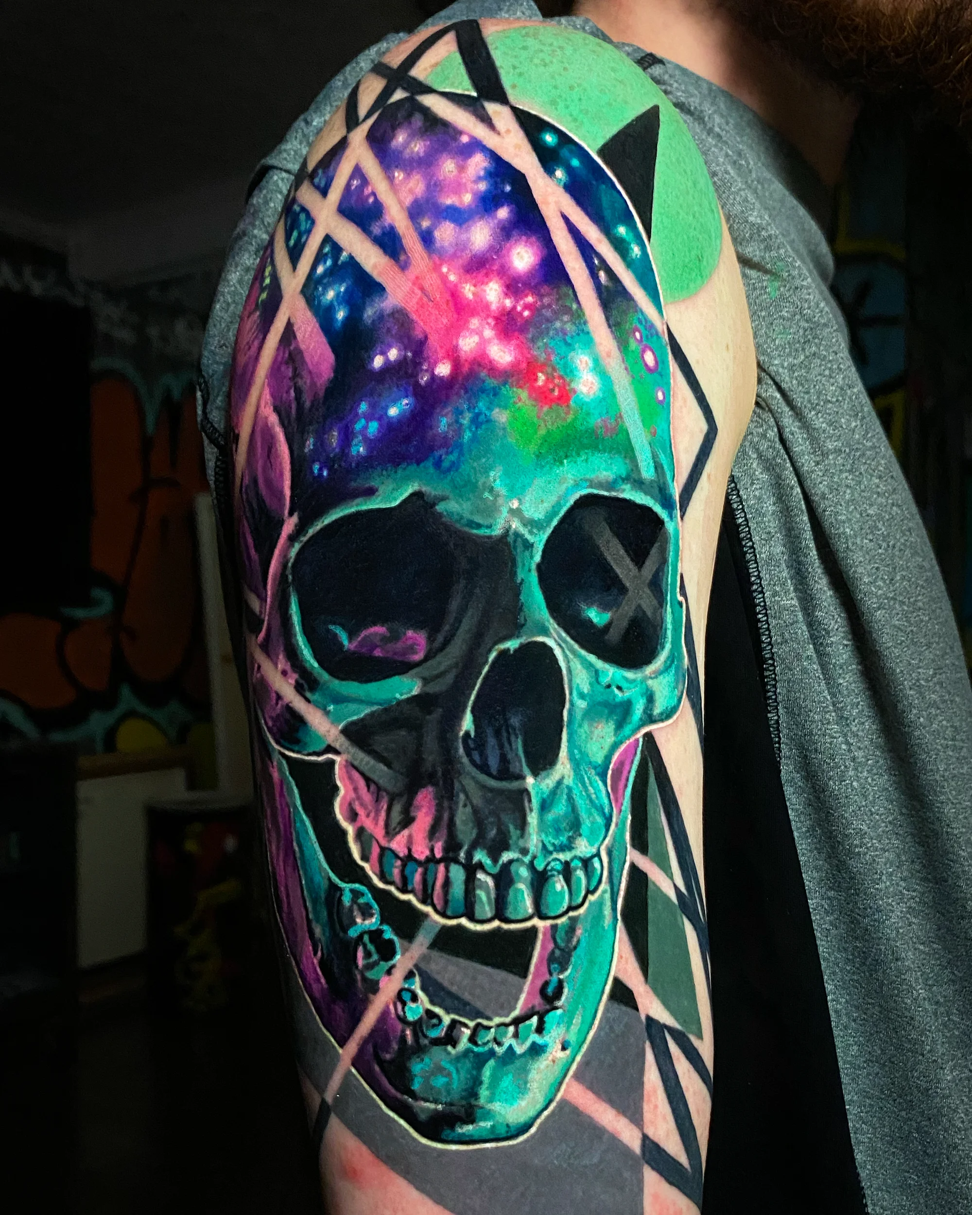 Color realism geometric galaxy skull shoulder cap tattoo by Austin tattoo artist Bobby Cupparo