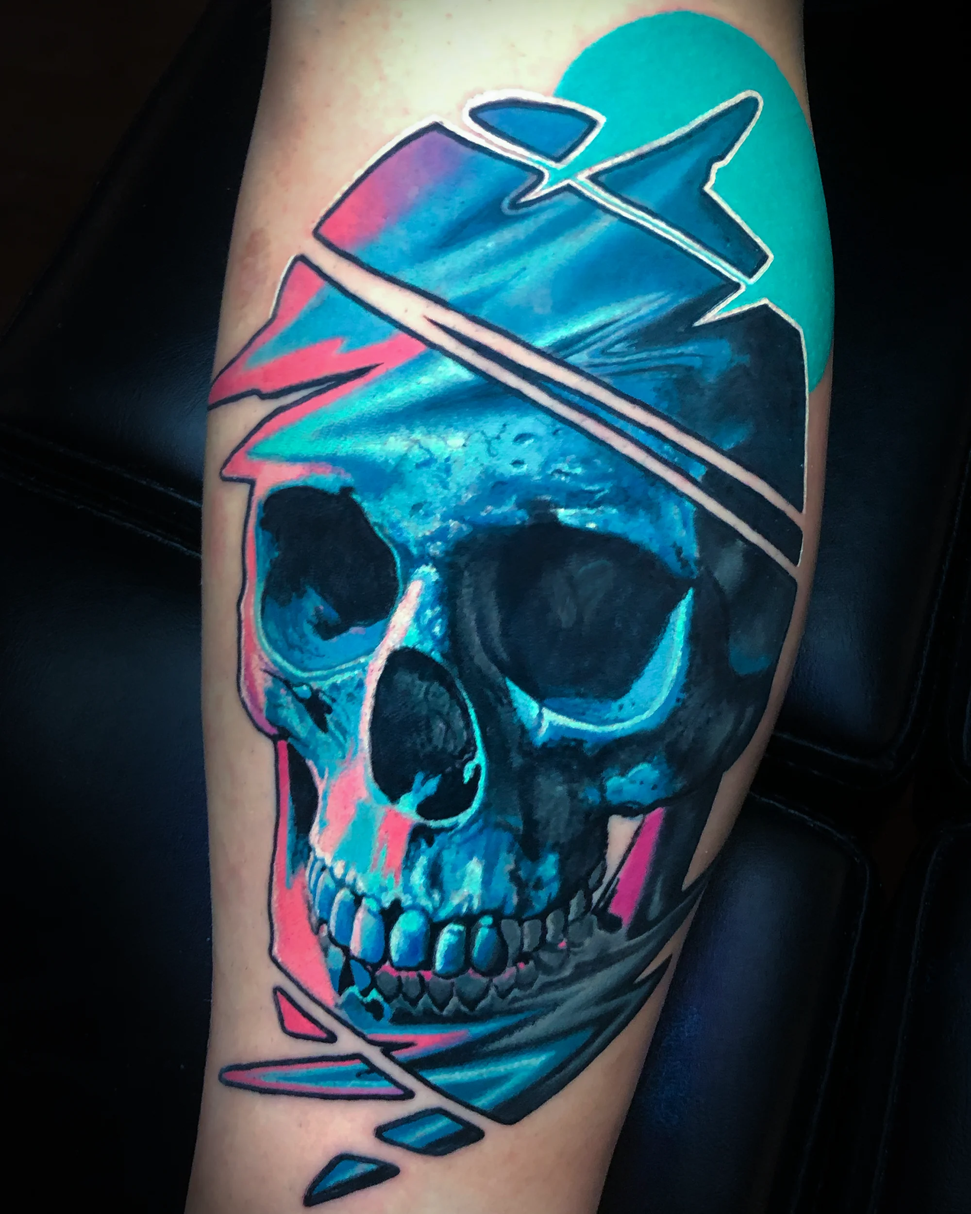 Color realism geometric neon skull forearm tattoo by Austin tattoo artist Bobby Cupparo