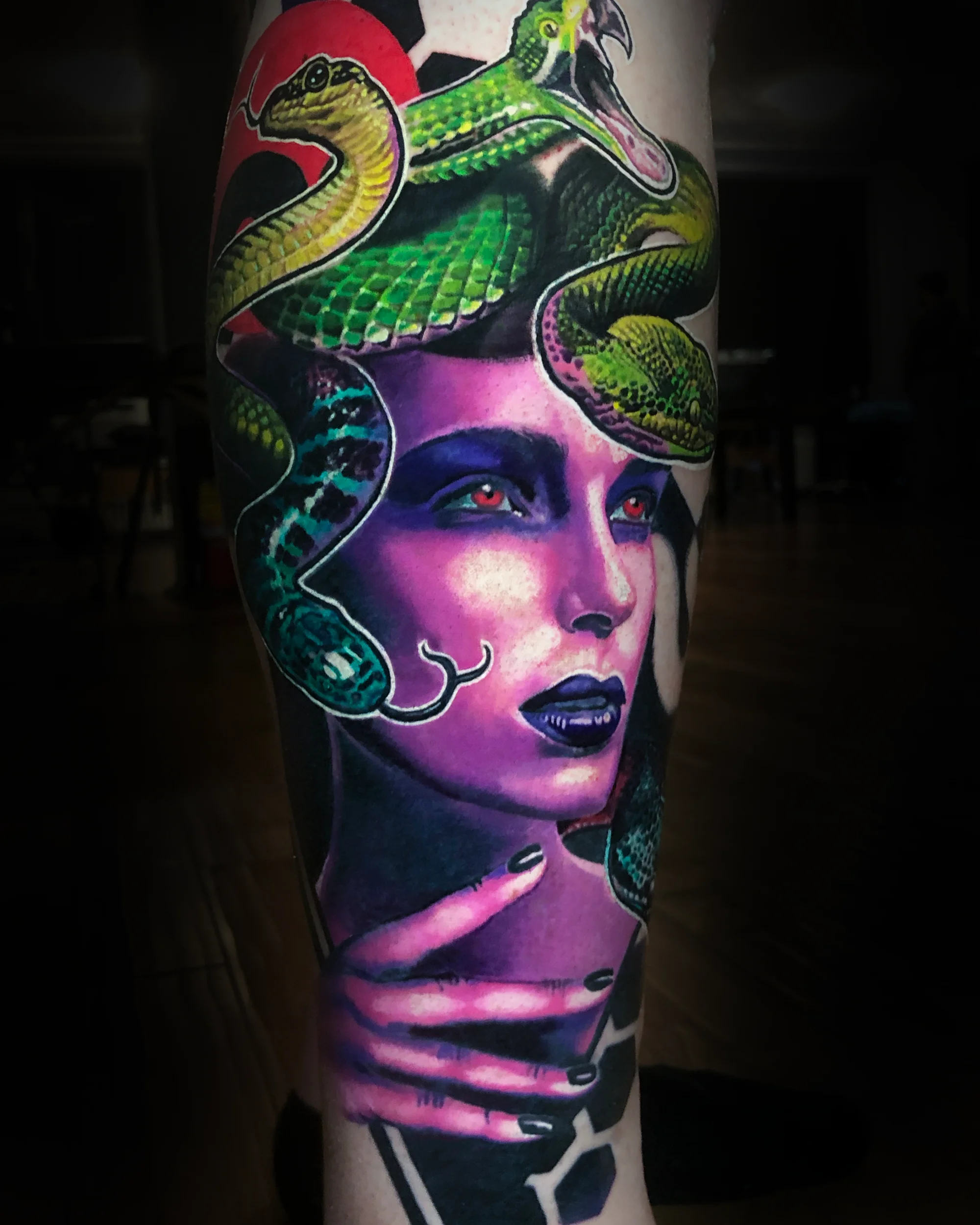 Color realism neon Medusa portrait tattoo by Austin tattoo artist Bobby Cupparo