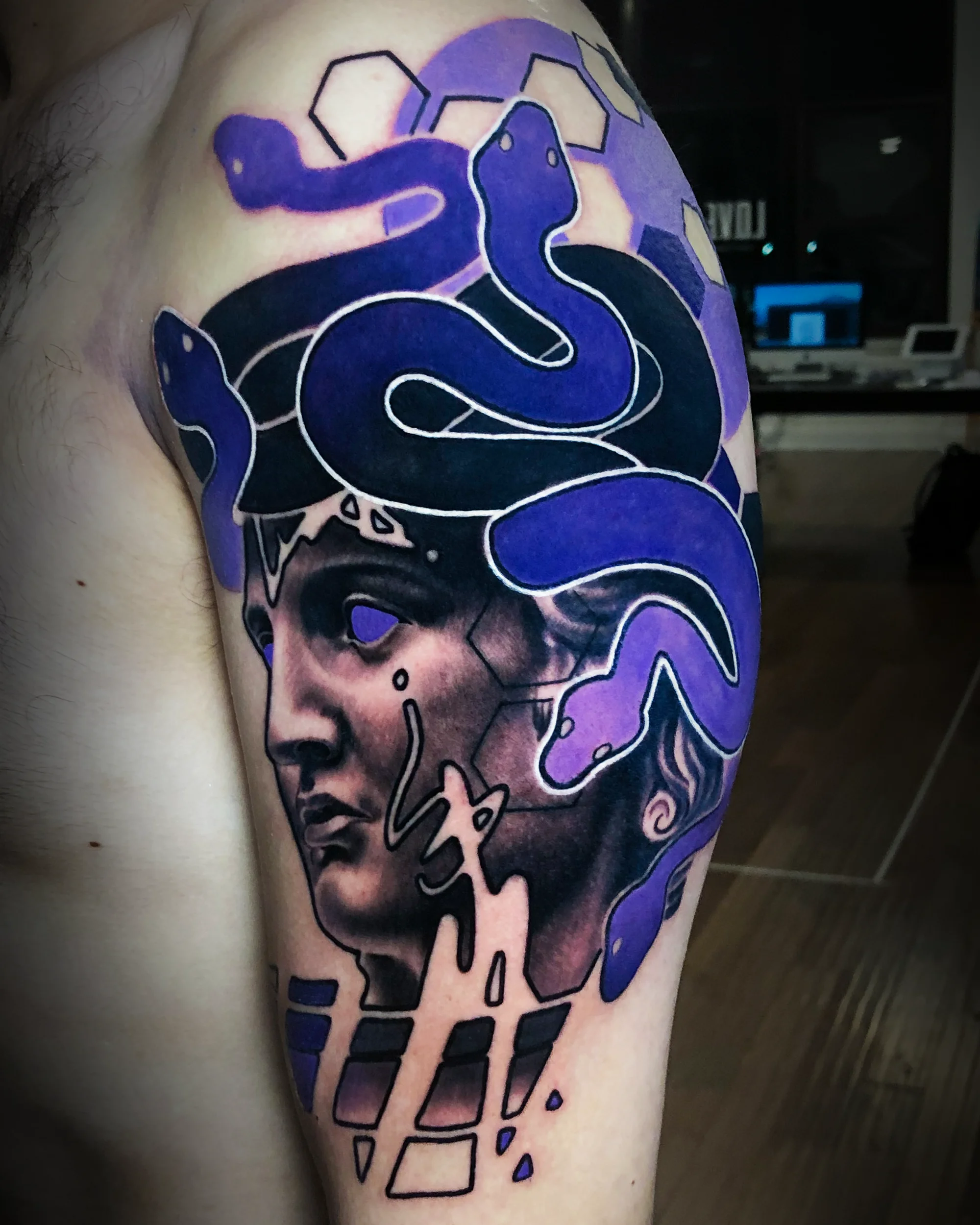 Color realism surreal Medusa statue with purple snake hair upper arm tattoo by Austin tattoo artist Bobby Cupparo