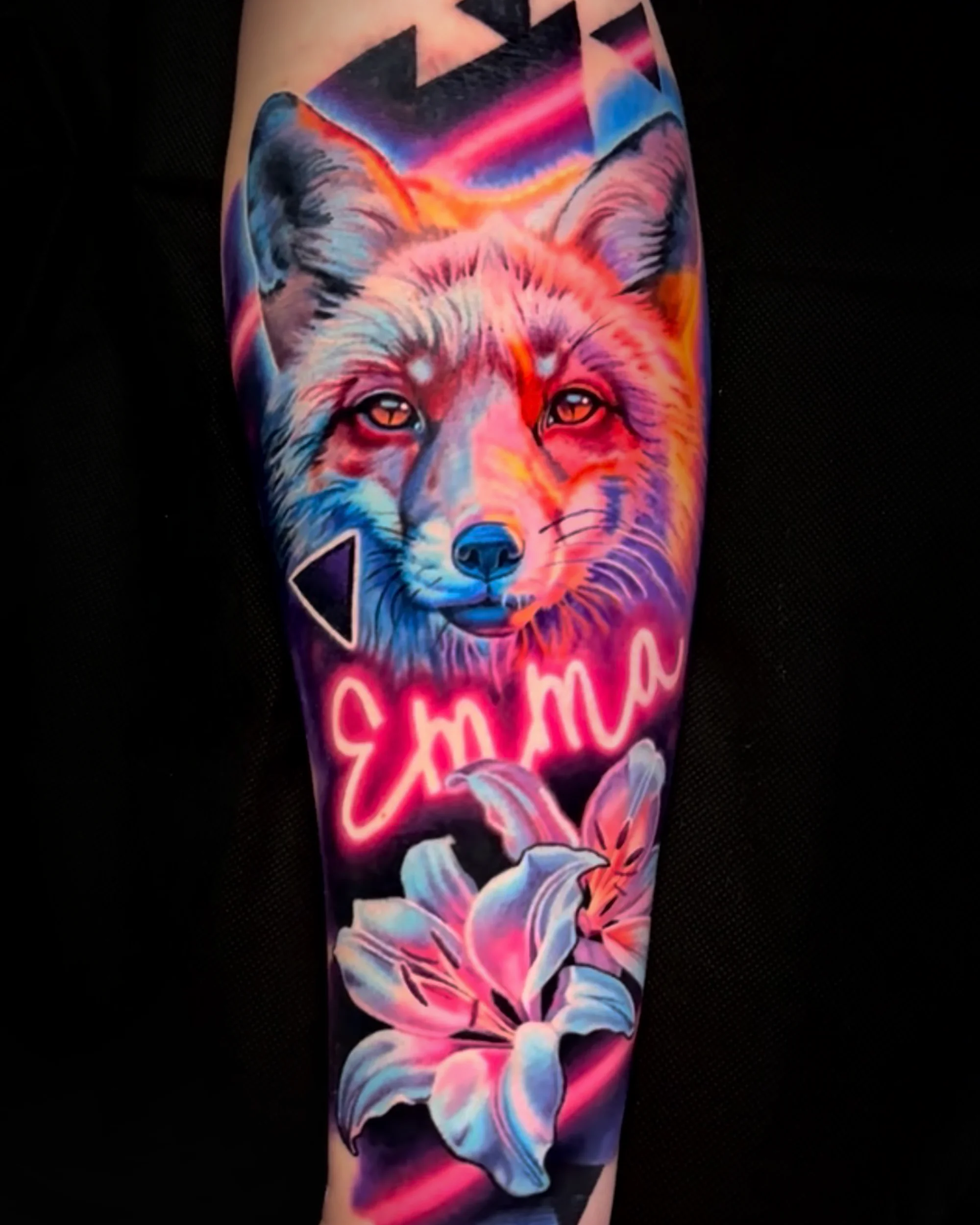 Surreal color neon fox with lily and neon lettering forearm tattoo by Austin tattoo artist Bobby Cupparo