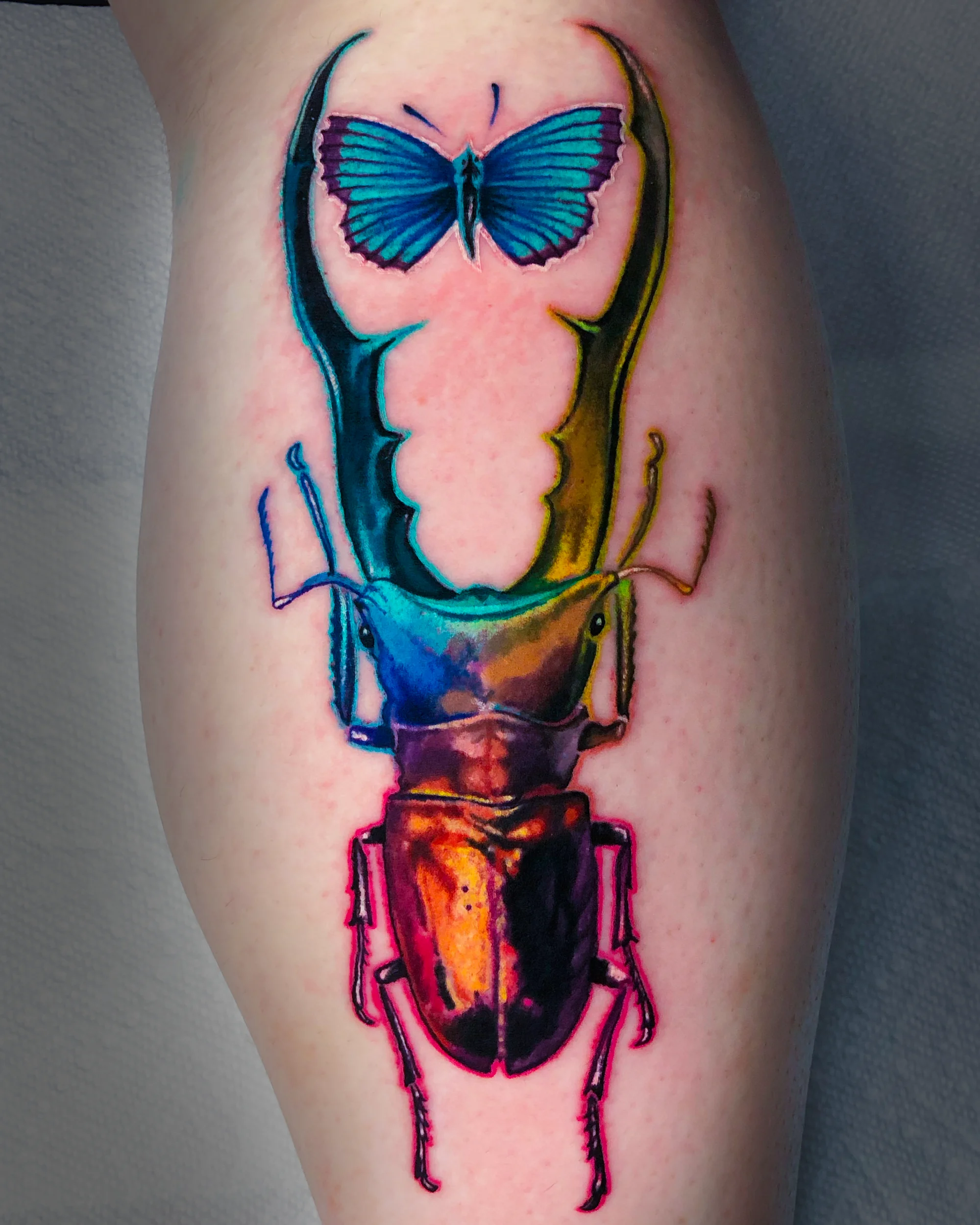Rainbow stag beetle butterfly forearm tattoo