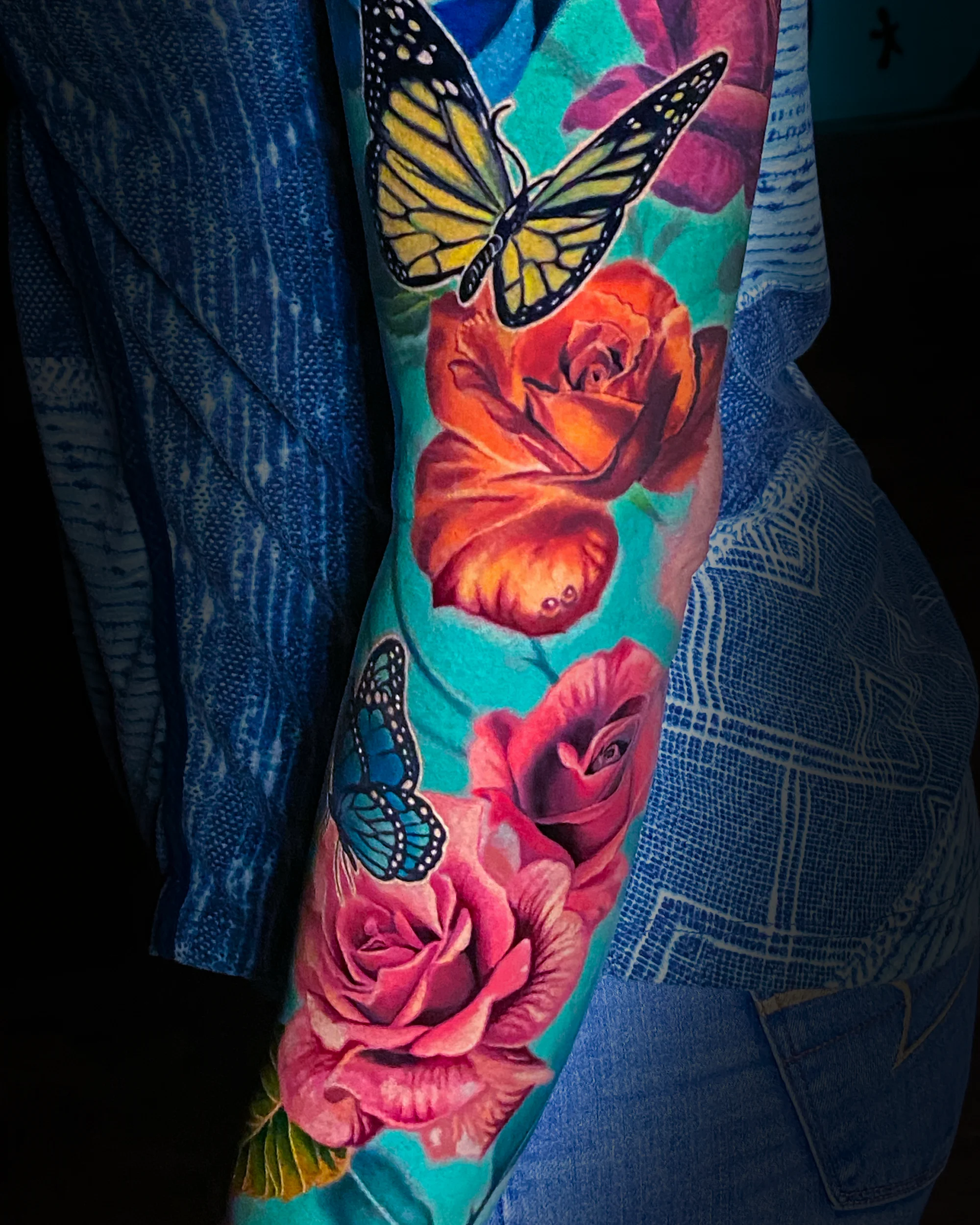 Color realism roses and butterflies full sleeve tattoo by Austin tattoo artist Bobby Cupparo