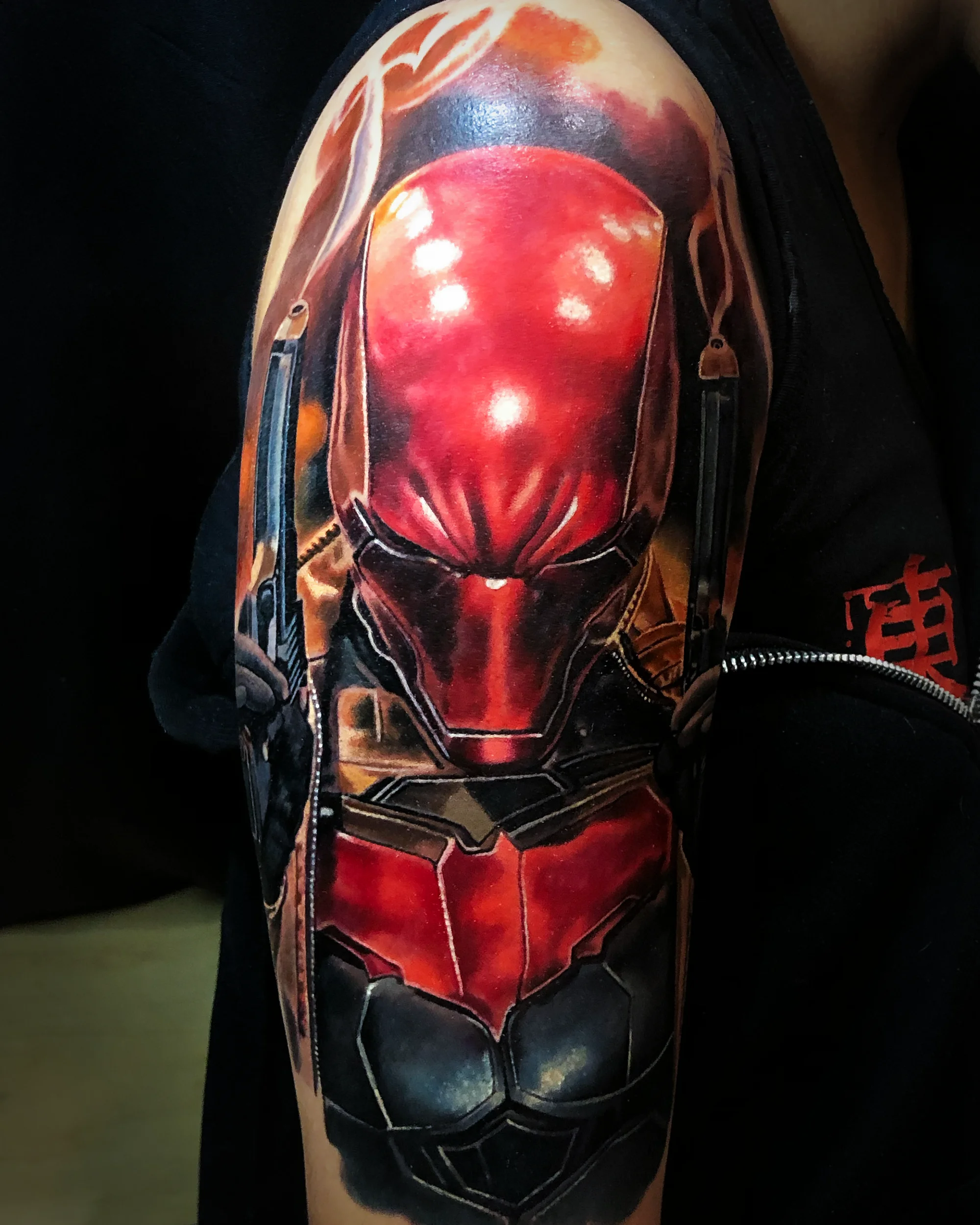 Color realism Red Hood DC Comics portrait upper arm tattoo by Austin tattoo artist Bobby Cupparo