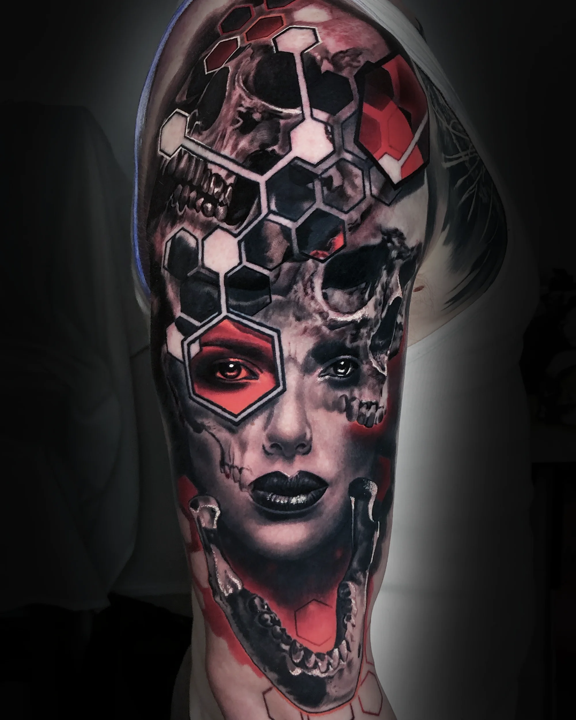 Surreal black and grey female skull honeycomb upper arm tattoo by Austin tattoo artist Bobby Cupparo