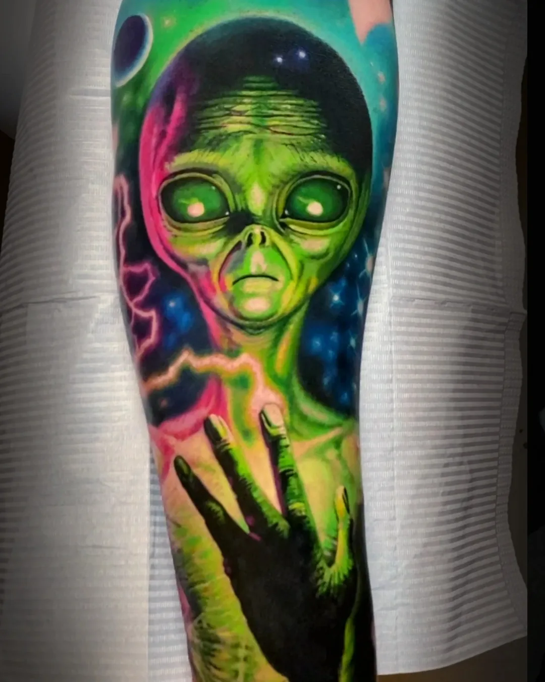 Surreal color alien portrait with galaxy cosmic background forearm tattoo by Austin tattoo artist Bobby Cupparo