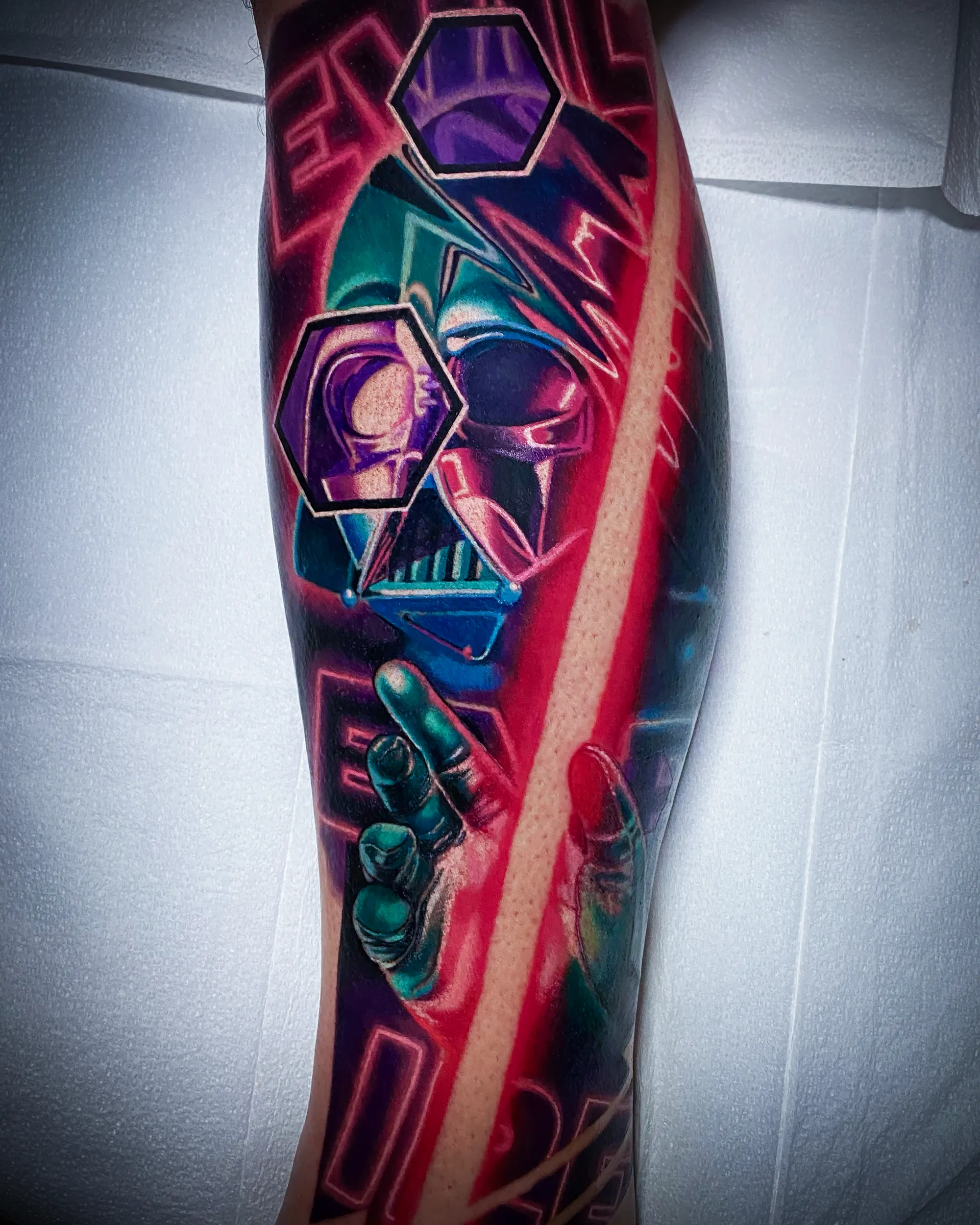 Surreal color Darth Vader neon lightsaber forearm tattoo by Austin tattoo artist Bobby Cupparo