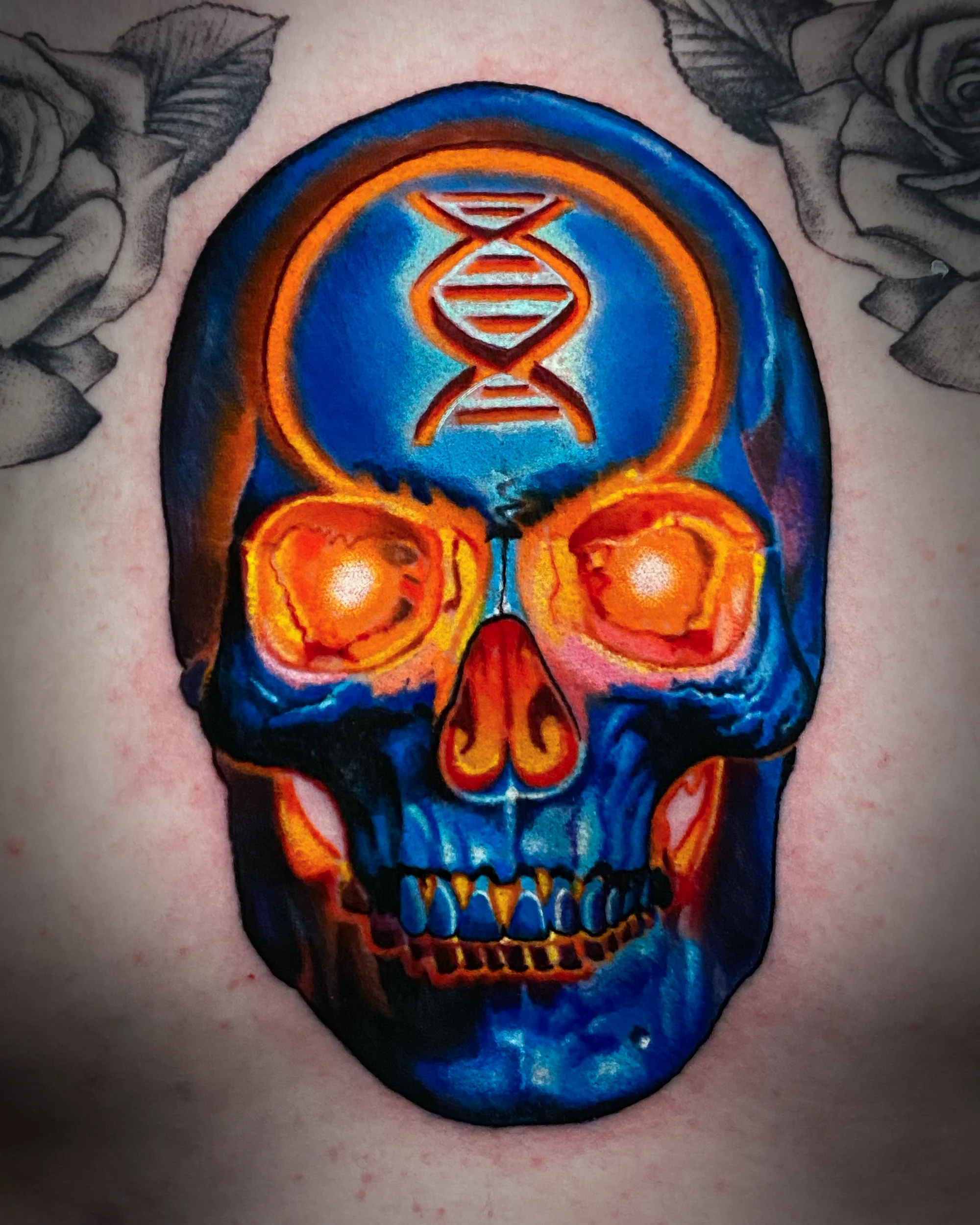 Surreal color DNA skull with glowing orange eye sockets chest tattoo by Austin tattoo artist Bobby Cupparo
