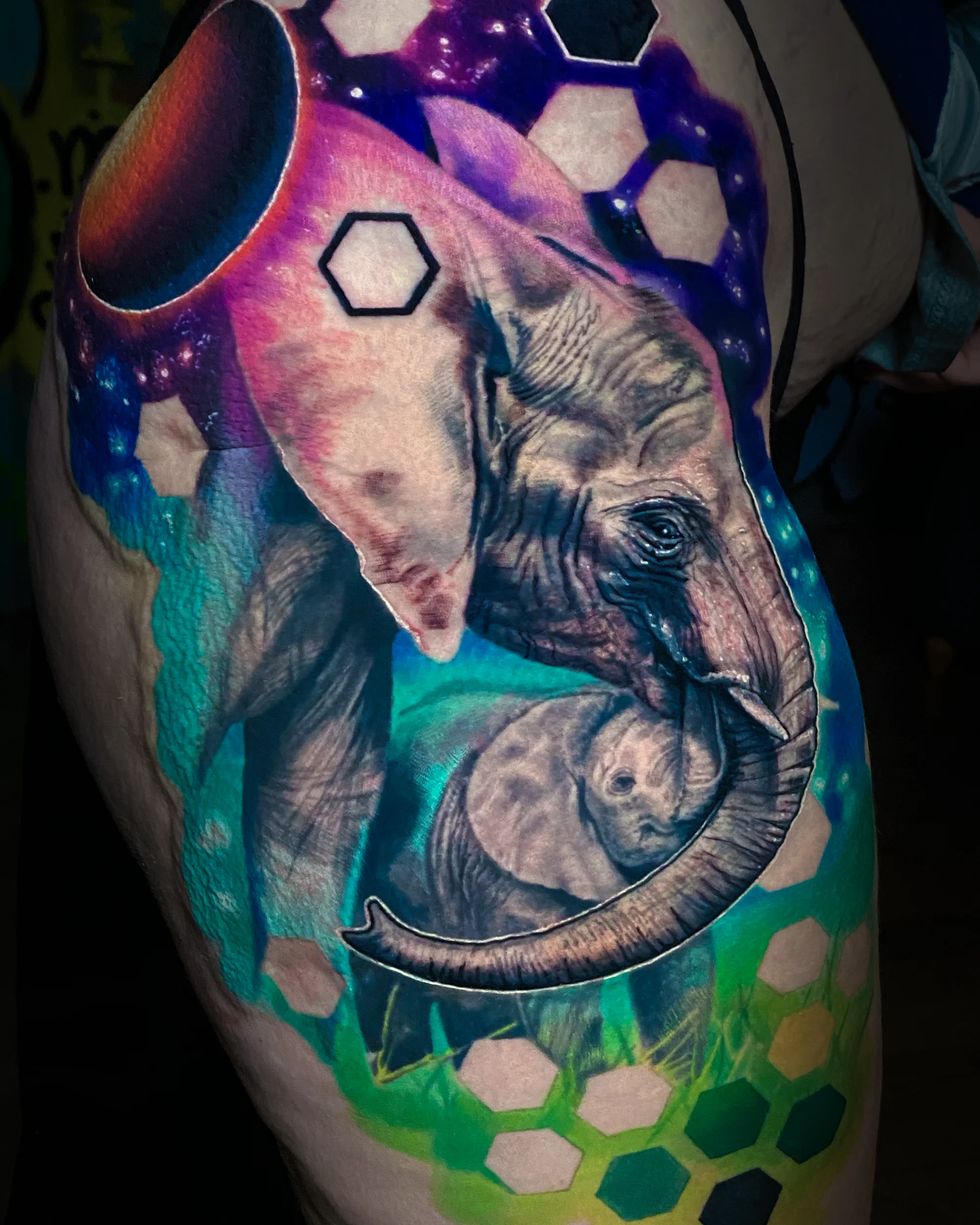 Surreal color galaxy elephant mother and baby thigh tattoo by Austin tattoo artist Bobby Cupparo