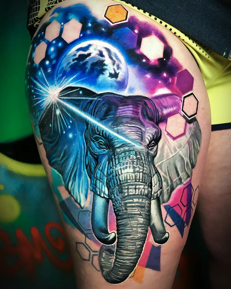 Galaxy elephant thigh tattoo in vivid color realism by Bobby Cupparo