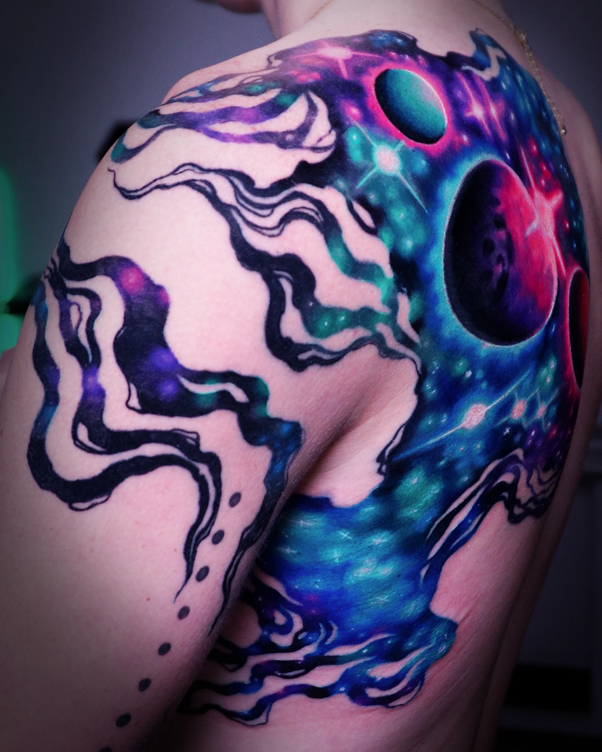 Surreal color galaxy jellyfish shoulder tattoo by Austin tattoo artist Bobby Cupparo