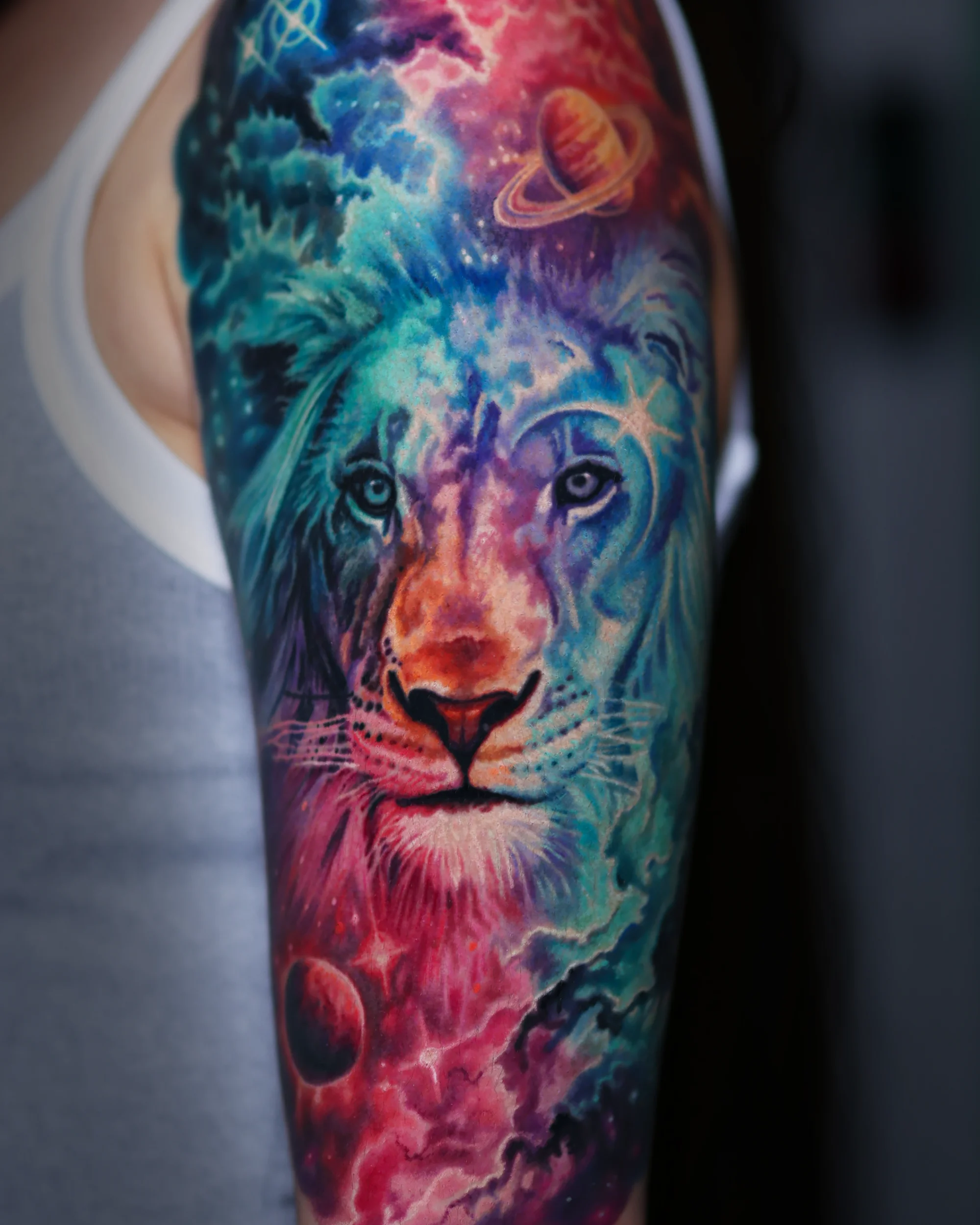 Surreal galaxy lion portrait with cosmic nebula sleeve tattoo by Austin tattoo artist Bobby Cupparo