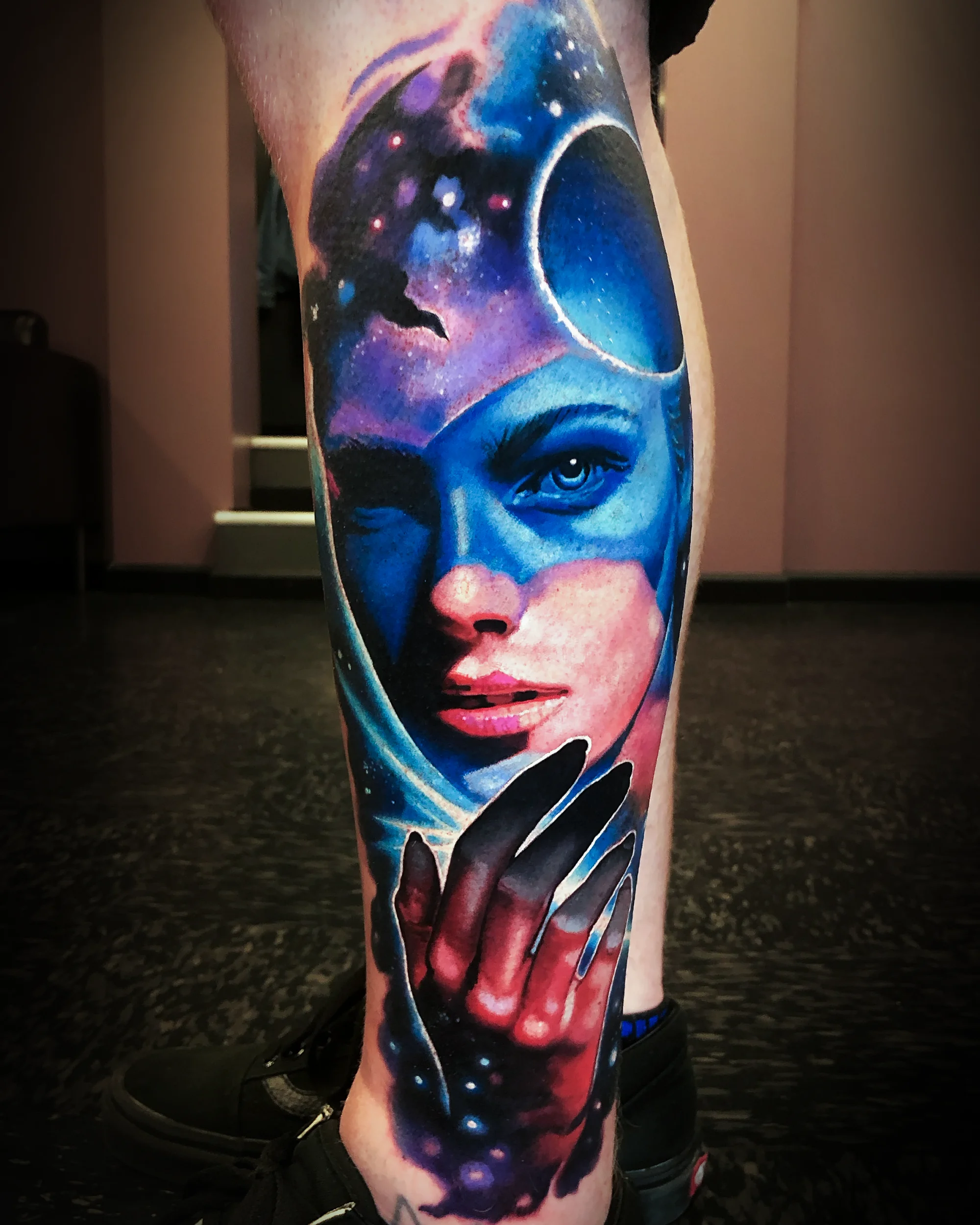 Surreal color realism galaxy woman with moon shin sleeve tattoo by Austin tattoo artist Bobby Cupparo