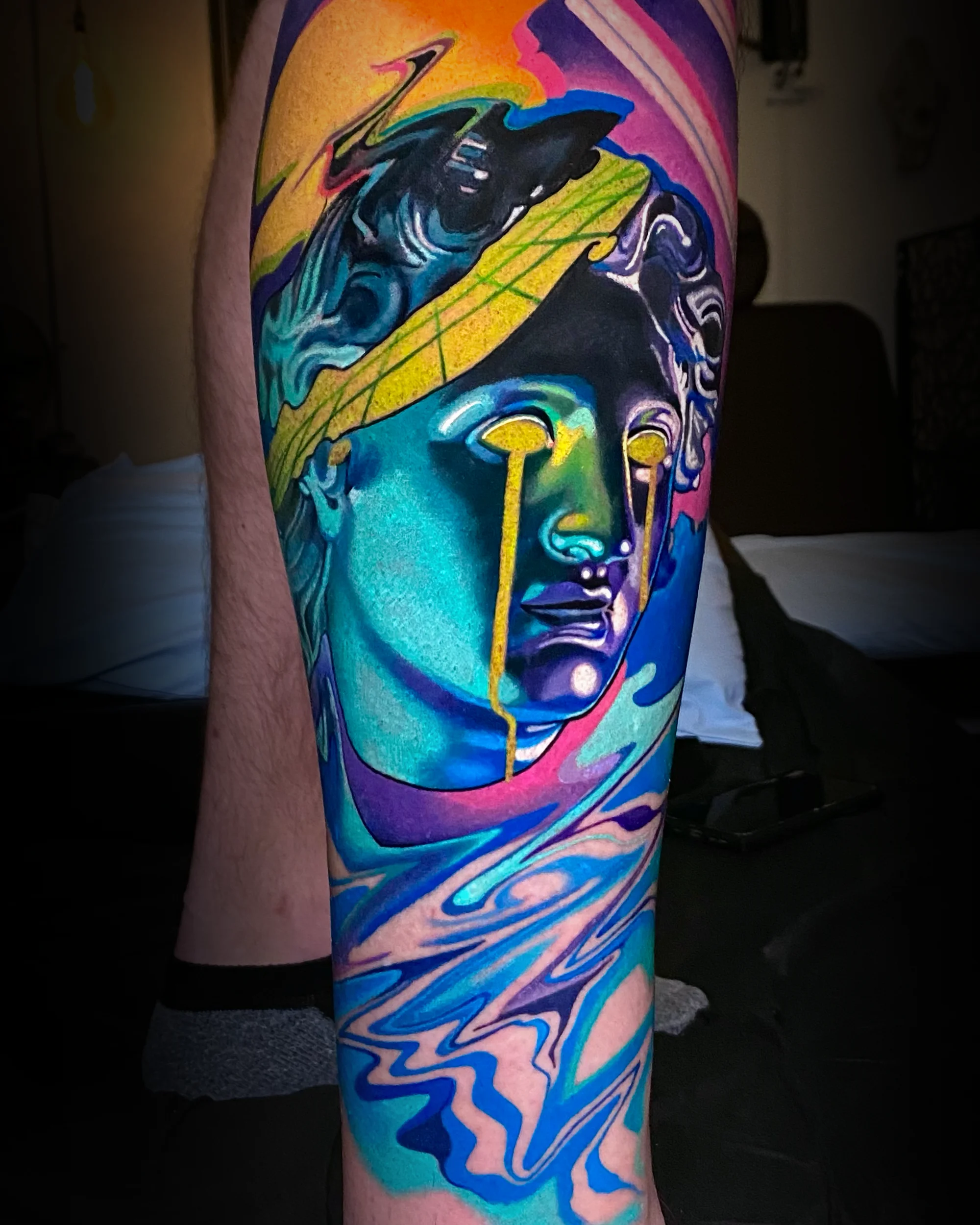 Surreal color melting Greek statue skull reveal thigh tattoo by Austin tattoo artist Bobby Cupparo