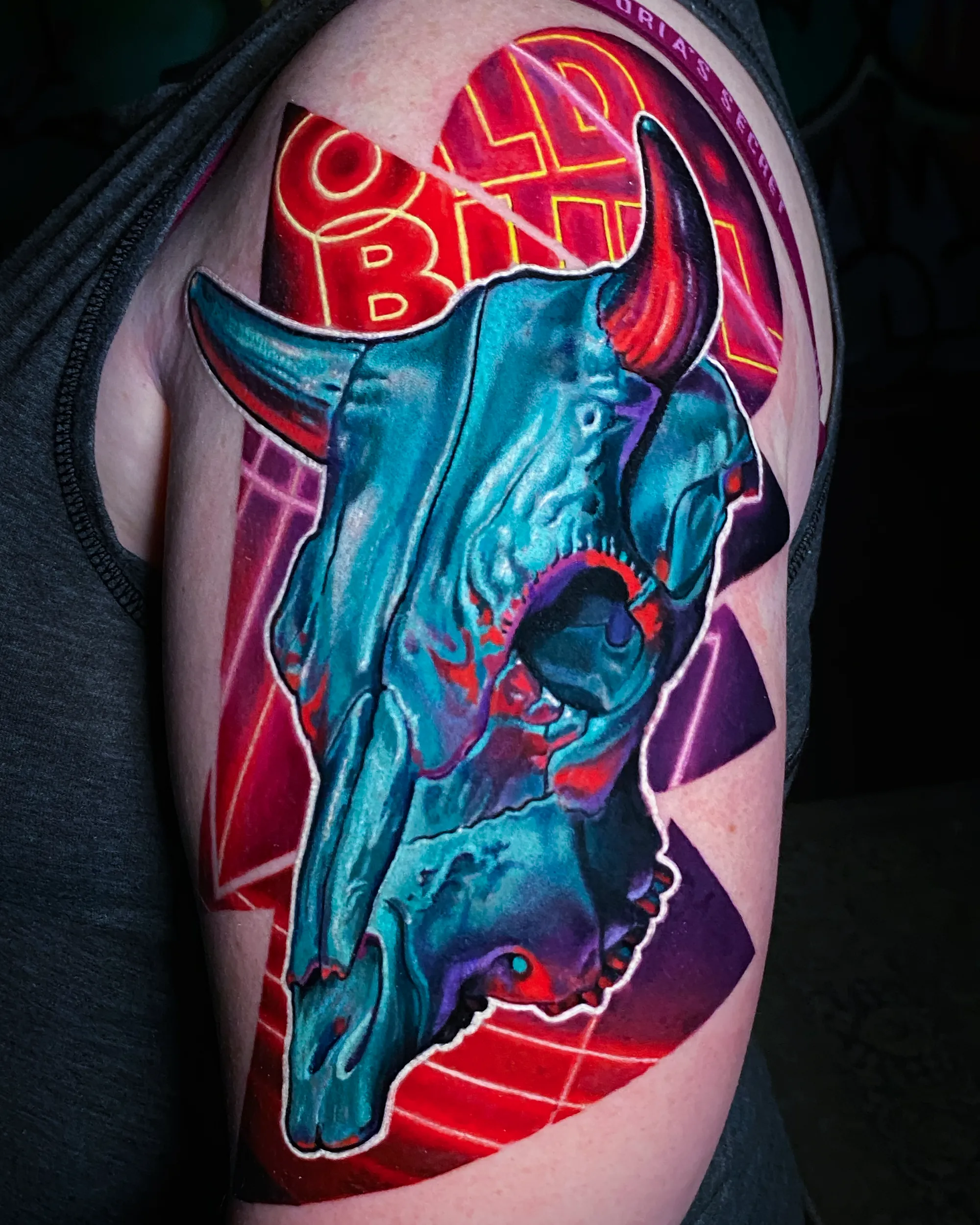 Surreal color neon bull skull shoulder tattoo by Austin tattoo artist Bobby Cupparo