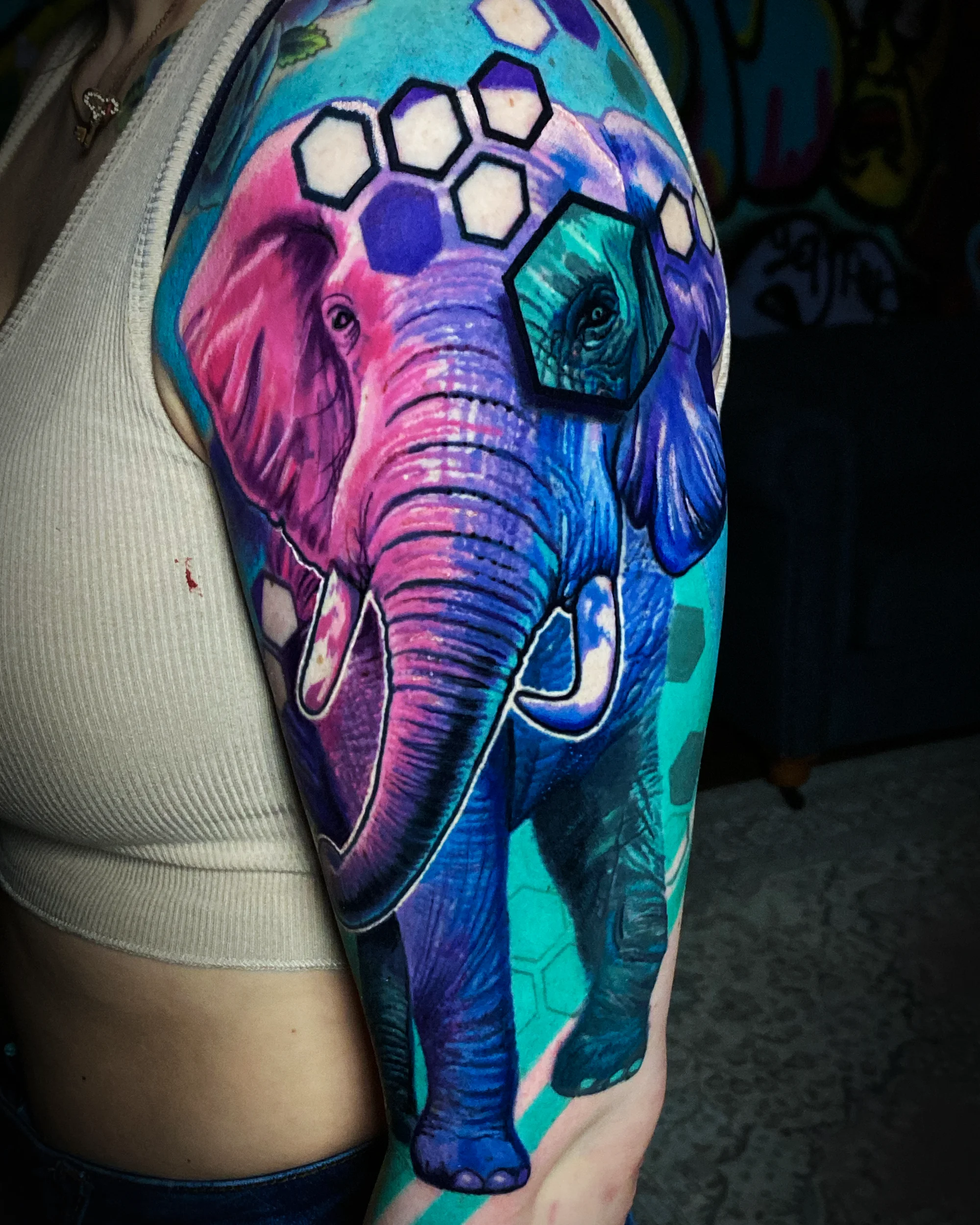 Neon elephant hexagon sleeve tattoo — follow on Instagram by Austin tattoo artist Bobby Cupparo