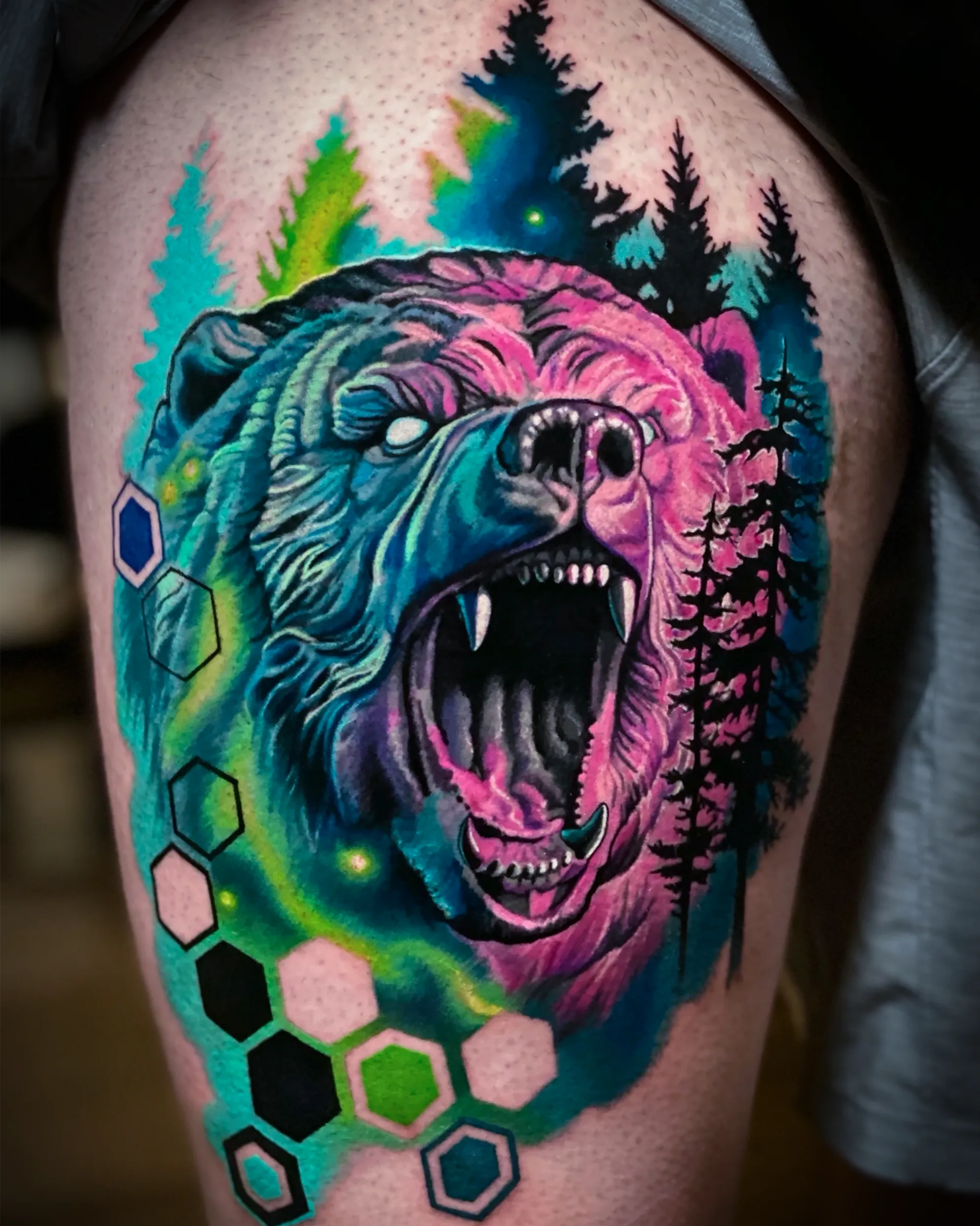 Surreal color roaring bear forest aurora thigh tattoo by Austin tattoo artist Bobby Cupparo