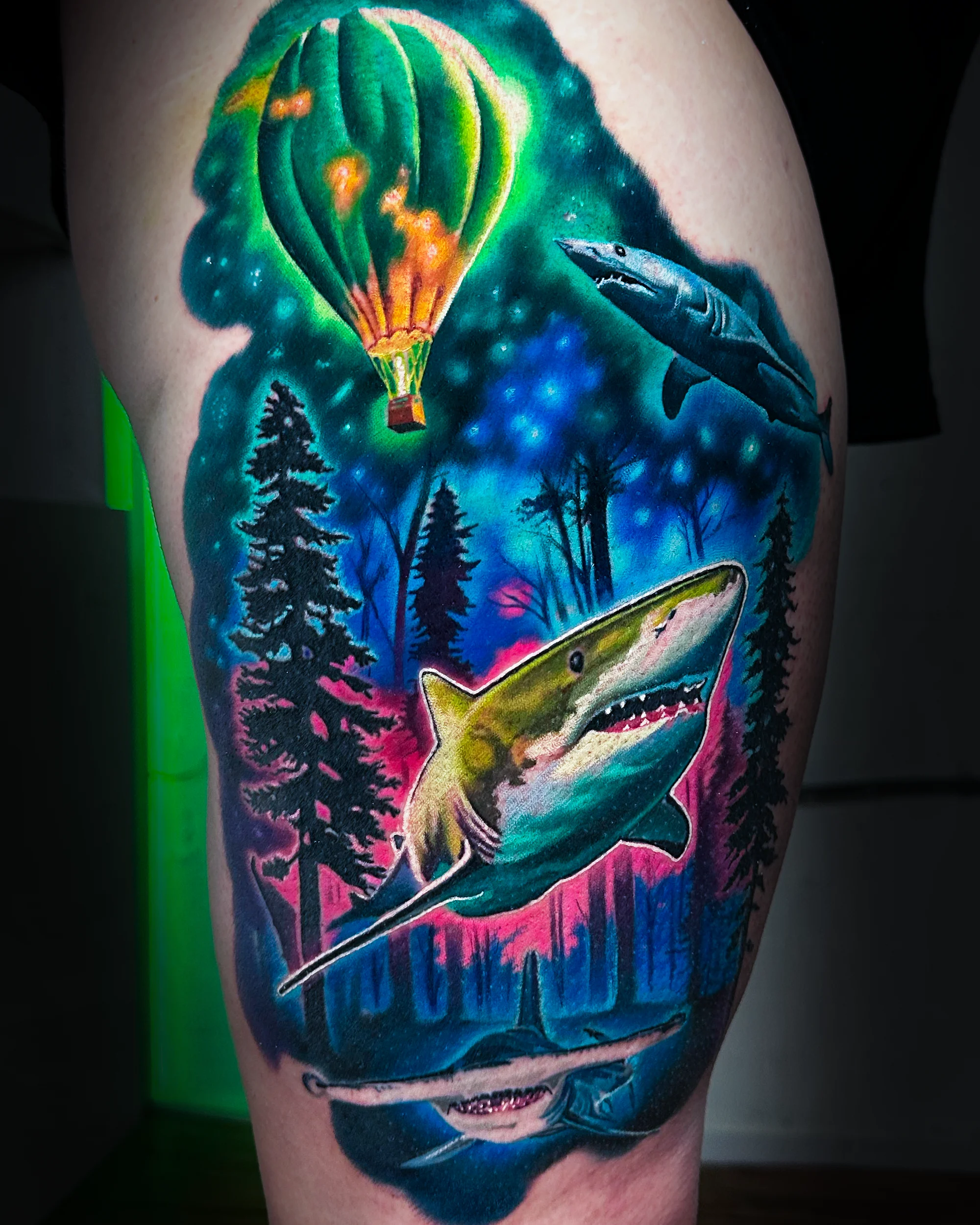 Surreal color sharks flying through galaxy forest aurora thigh tattoo by Austin tattoo artist Bobby Cupparo